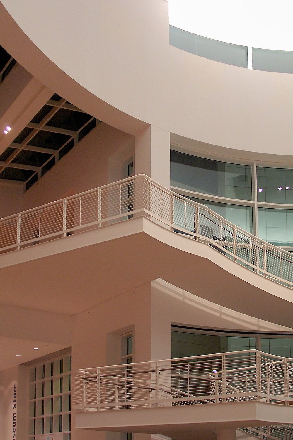 White staircases curving up through a light-filled atrium